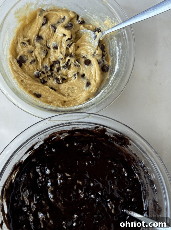 Bowls filled with rich brownie batter and sweet cookie dough, ready to be combined for Snickers Brookies.