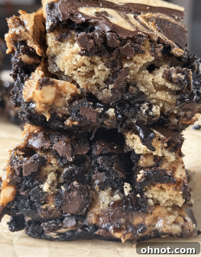 A close-up of a cut Snickers Brookie, showing the rich chocolate, caramel, and peanut layers.