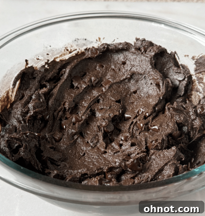 Thick, rich sweet potato protein brownie batter in a bowl.