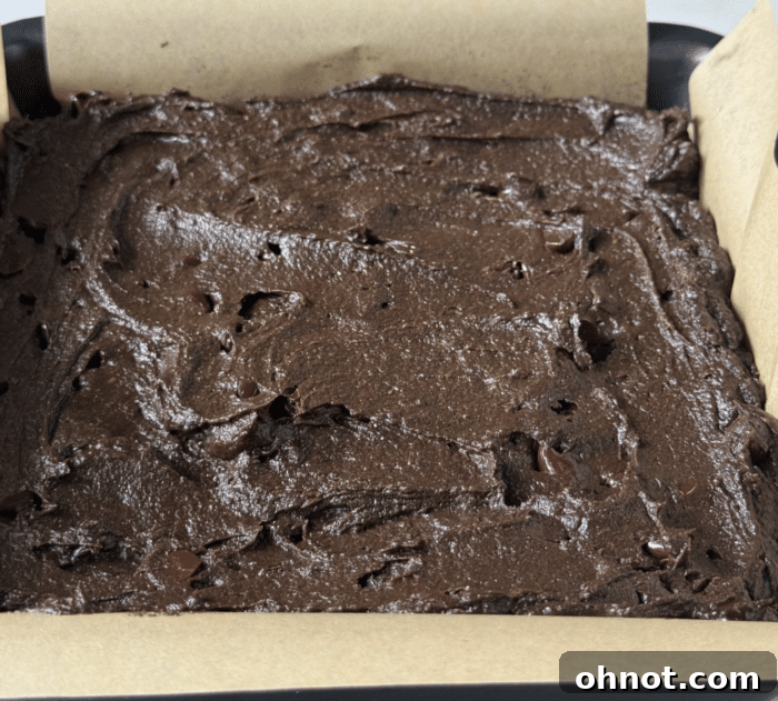 Square baking pan filled with smooth protein brownie dough.