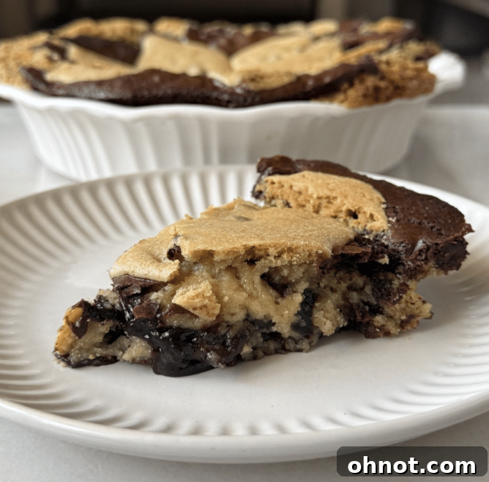 Close-up of the layered Cookie Brownie Pie before baking, showing the distinct cookie base and brownie batter.