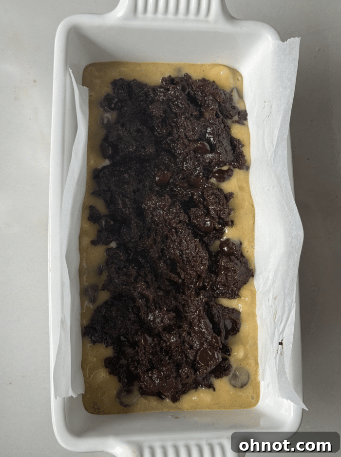 Close-up of brownie batter being mixed, showing its rich, dark color and smooth texture.