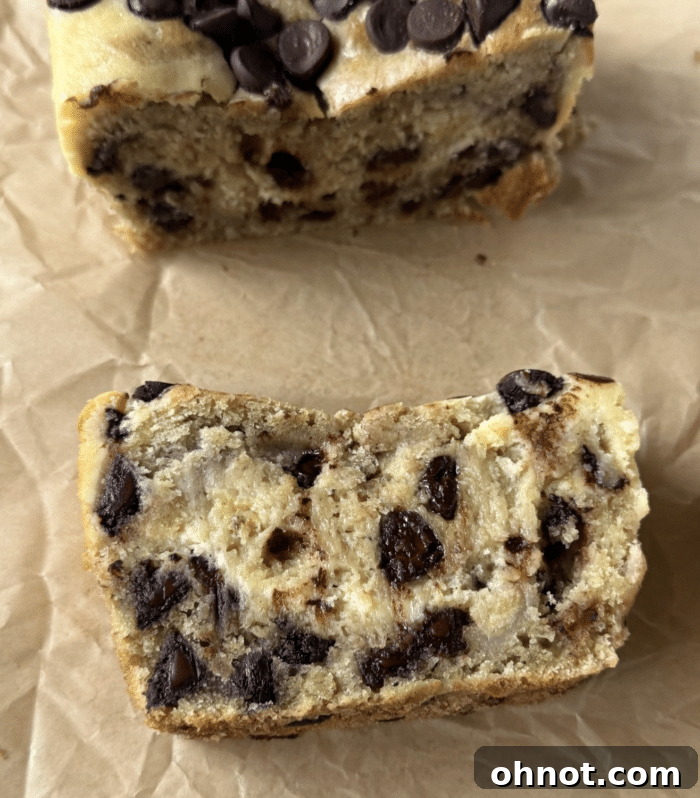 A close-up of the swirled batter before baking, showing the distinct cheesecake and banana bread layers with chocolate chips.