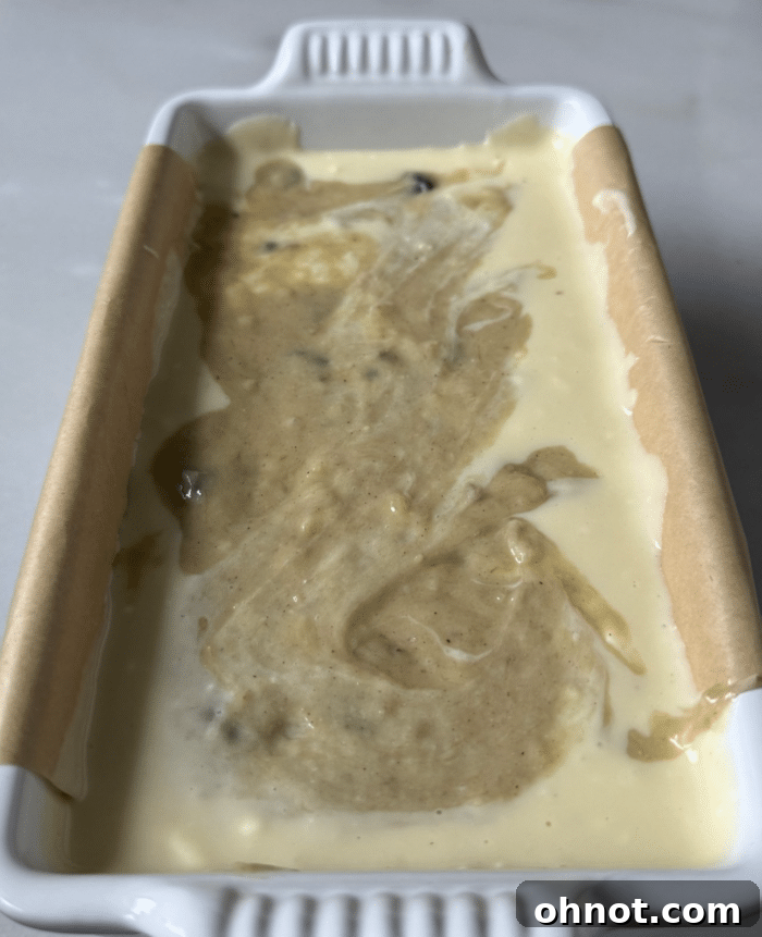 The final cheesecake swirl bread batter in the pan, ready for baking.