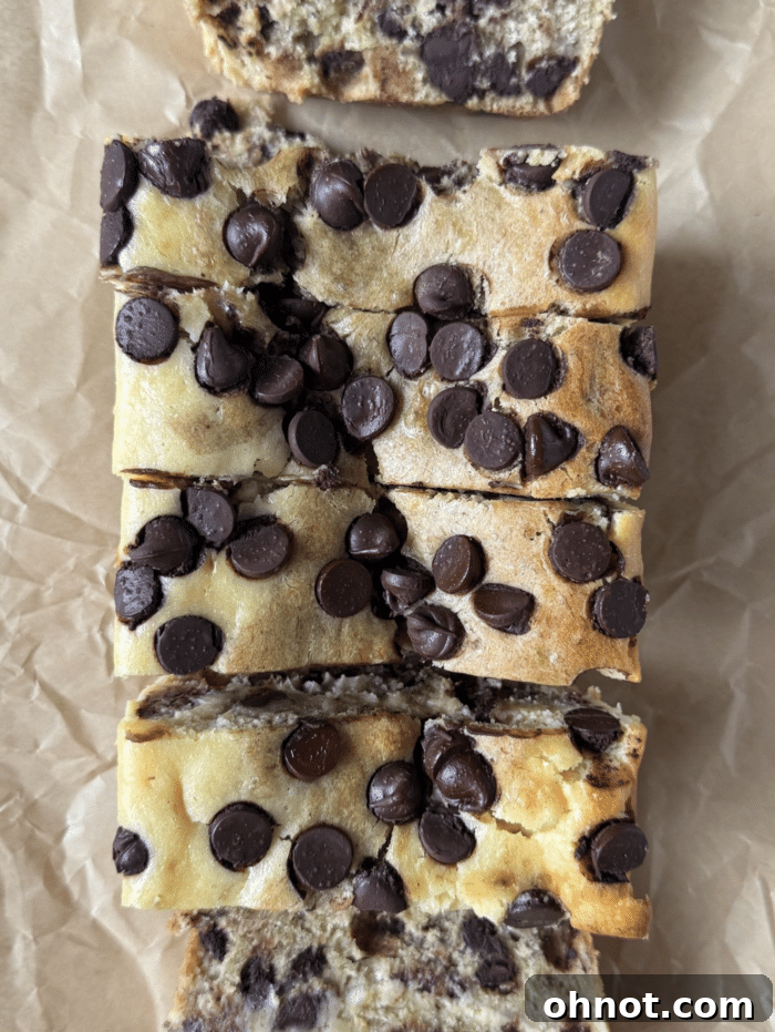 Beautifully sliced cheesecake banana bread, showcasing the distinct layers and abundant chocolate chips.