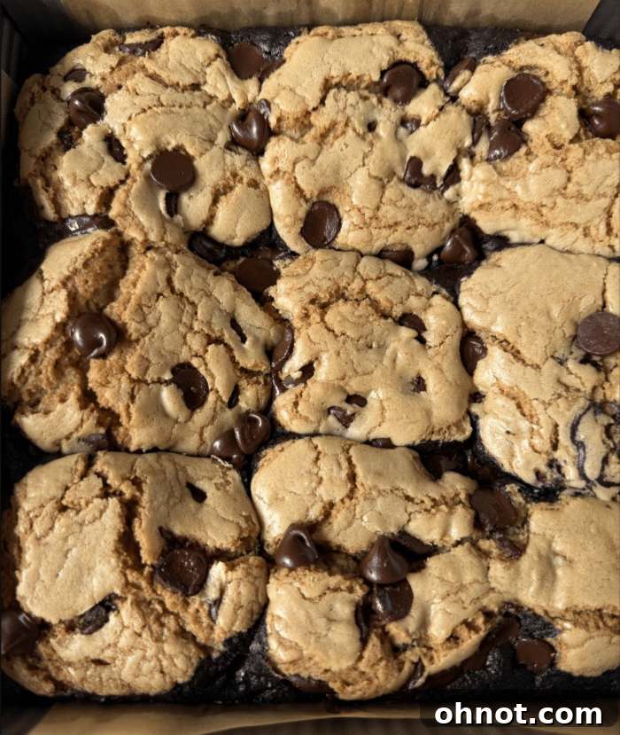 Close-up of brownie batter with cookie dough balls on top before baking.