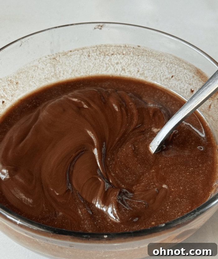 Melted chocolate in glass bowl.